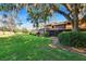 Lawn and backyard with covered and screened in patio near mature shady trees at 29909 Baywood Ln, Wesley Chapel, FL 33543