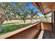 Balcony overlooking green golf course and clear blue skies framed by beautiful trees at 29909 Baywood Ln, Wesley Chapel, FL 33543