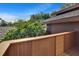 Balcony with wood railing and lush green treetop views under a clear blue sky at 29909 Baywood Ln, Wesley Chapel, FL 33543