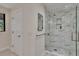 Shower featuring a frameless glass enclosure with marble tiling, offering a spa-like experience at 29909 Baywood Ln, Wesley Chapel, FL 33543