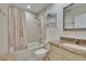 Well-lit bathroom features a shower-tub combo, granite countertop, and a decorative shower curtain at 29909 Baywood Ln, Wesley Chapel, FL 33543