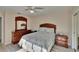 Bedroom featuring a ceiling fan, dresser, bedside tables, and a plush bedspread at 29909 Baywood Ln, Wesley Chapel, FL 33543