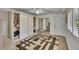 Bright bedroom featuring built-in storage, a ceiling fan, a mirrored closet, and wood-look flooring at 29909 Baywood Ln, Wesley Chapel, FL 33543
