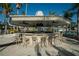 Outdoor community bar with ample seating, ceiling fans, and a welcoming atmosphere for socializing at 29909 Baywood Ln, Wesley Chapel, FL 33543