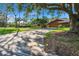 Charming single-story home with lush landscaping and a long private driveway leading to the attached garage at 29909 Baywood Ln, Wesley Chapel, FL 33543