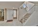 Inviting foyer with tile flooring, white door, a staircase to the upper level, and neutral tones at 29909 Baywood Ln, Wesley Chapel, FL 33543
