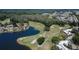 Aerial view of an immaculately maintained golf course with a pond surrounded by mature trees at 29909 Baywood Ln, Wesley Chapel, FL 33543