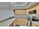 Well-lit kitchen with granite countertops, stainless steel appliances, and ample cabinet space at 29909 Baywood Ln, Wesley Chapel, FL 33543