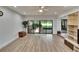 Comfortable living room featuring wood floors, sliding glass doors to patio, and entertainment center at 29909 Baywood Ln, Wesley Chapel, FL 33543