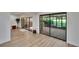 Spacious living area with wood floors and sliding doors to a screened lanai at 29909 Baywood Ln, Wesley Chapel, FL 33543