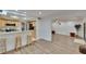 Open concept living area adjacent to the kitchen, featuring wood floors and seamless flow at 29909 Baywood Ln, Wesley Chapel, FL 33543