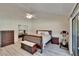 Cozy bedroom features neutral walls and hardwood flooring and ensuite bath and closet at 29909 Baywood Ln, Wesley Chapel, FL 33543