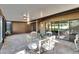 Enclosed patio with brick floor, glass table and chairs with view to backyard at 29909 Baywood Ln, Wesley Chapel, FL 33543