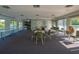 Spacious recreation room featuring tables, chairs, kitchenette, and convenient access to outdoor amenities at 29909 Baywood Ln, Wesley Chapel, FL 33543
