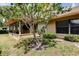 Well-maintained backyard with lush greenery, mature tree, and a cozy screened-in porch at 3310 Tanglewood Trl, Palm Harbor, FL 34685