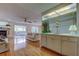 Entertainer's wet bar with mirrored accents, cabinetry, and access to living areas, ideal for hosting guests at 3310 Tanglewood Trl, Palm Harbor, FL 34685
