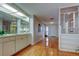 Stylish wet bar with mirrored backsplash, built-in cabinetry, and hardwood floors at 3310 Tanglewood Trl, Palm Harbor, FL 34685