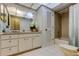 Bathroom vanity with a white countertop, white cabinets, and a bathtub with shower head at 3310 Tanglewood Trl, Palm Harbor, FL 34685