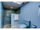 Light-blue bathroom with blue square tiles and white patterned flooring at 3310 Tanglewood Trl, Palm Harbor, FL 34685