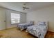 Bedroom featuring two twin beds, carpet floor, ceiling fan, and a window at 3310 Tanglewood Trl, Palm Harbor, FL 34685