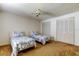 Bedroom featuring two twin beds, carpet floor, ceiling fan, and two closets at 3310 Tanglewood Trl, Palm Harbor, FL 34685