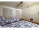 Bedroom featuring two twin beds, carpet floor, ceiling fan, and two closets at 3310 Tanglewood Trl, Palm Harbor, FL 34685