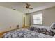 Bedroom featuring two twin beds, carpet floor, ceiling fan, and a window at 3310 Tanglewood Trl, Palm Harbor, FL 34685