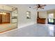 Tiled bonus room with kitchen pass-through, a window with a blind, and wooden cabinetry at 3310 Tanglewood Trl, Palm Harbor, FL 34685