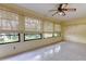 Tiled bonus room with natural light streaming in from several windows with privacy blinds at 3310 Tanglewood Trl, Palm Harbor, FL 34685