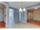 Dining area highlighting tiled floors, a chandelier, and access to the laundry room and other spaces at 3310 Tanglewood Trl, Palm Harbor, FL 34685