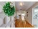 Inviting entryway featuring a decorative wreath and gleaming hardwood floors, leading into a bright living space at 3310 Tanglewood Trl, Palm Harbor, FL 34685
