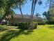 Charming home with a well-manicured lawn and lush, mature landscaping at 3310 Tanglewood Trl, Palm Harbor, FL 34685