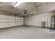 Functional garage featuring a water heater and ample room for parking and storage at 3310 Tanglewood Trl, Palm Harbor, FL 34685