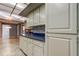 Spacious kitchen featuring custom white cabinets, tile floors, and light countertops at 3310 Tanglewood Trl, Palm Harbor, FL 34685