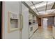 Bright kitchen featuring stainless steel refrigerator and view to the dining room at 3310 Tanglewood Trl, Palm Harbor, FL 34685