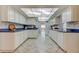Well-lit kitchen with tile floors, ample cabinets, and light countertops at 3310 Tanglewood Trl, Palm Harbor, FL 34685