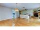 Bright living area with fireplace, ceiling fan, hardwood floors and access to kitchen and other living areas at 3310 Tanglewood Trl, Palm Harbor, FL 34685