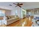 Well-lit living area showcasing hardwood floors, a built-in bar, and access to other areas of the home at 3310 Tanglewood Trl, Palm Harbor, FL 34685