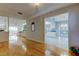 Bright living room showcasing hardwood floors, an open floorplan, and seamless transitions to the kitchen at 3310 Tanglewood Trl, Palm Harbor, FL 34685