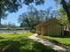 View of the community pool house situated on a verdant, landscaped lot at 3310 Tanglewood Trl, Palm Harbor, FL 34685