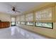Bright sunroom with tile floors, many windows, and woven shades allowing plenty of natural light at 3310 Tanglewood Trl, Palm Harbor, FL 34685