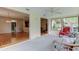 Bright sunroom transitions to living spaces, offering natural light and seamless flow throughout the home at 3310 Tanglewood Trl, Palm Harbor, FL 34685
