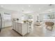 Open-concept kitchen and living area with stainless appliances and lots of natural light at 4275 Big Sky Dr, Spring Hill, FL 34604
