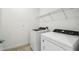 Laundry room featuring a washer, dryer, and storage shelf at 4275 Big Sky Dr, Spring Hill, FL 34604