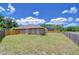 Large, grassy backyard enclosed by a wooden fence, offering privacy and ample space for recreation at 4503 Lace Cascade Ct, Lutz, FL 33558