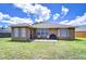Well-maintained backyard featuring a cozy patio, perfect for outdoor dining and entertaining with lush green grass at 4503 Lace Cascade Ct, Lutz, FL 33558