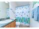 Charming bathroom featuring a vanity with sink and a shower with a themed shower curtain at 4503 Lace Cascade Ct, Lutz, FL 33558