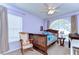 This bedroom features a rocking chair, toys, and soft neutral colors at 4503 Lace Cascade Ct, Lutz, FL 33558