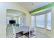 Bright breakfast nook boasts bay windows and a charming dining set with seating for four at 4503 Lace Cascade Ct, Lutz, FL 33558