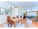 Open dining area flowing into a living room with a vaulted ceiling and lots of natural light at 4503 Lace Cascade Ct, Lutz, FL 33558